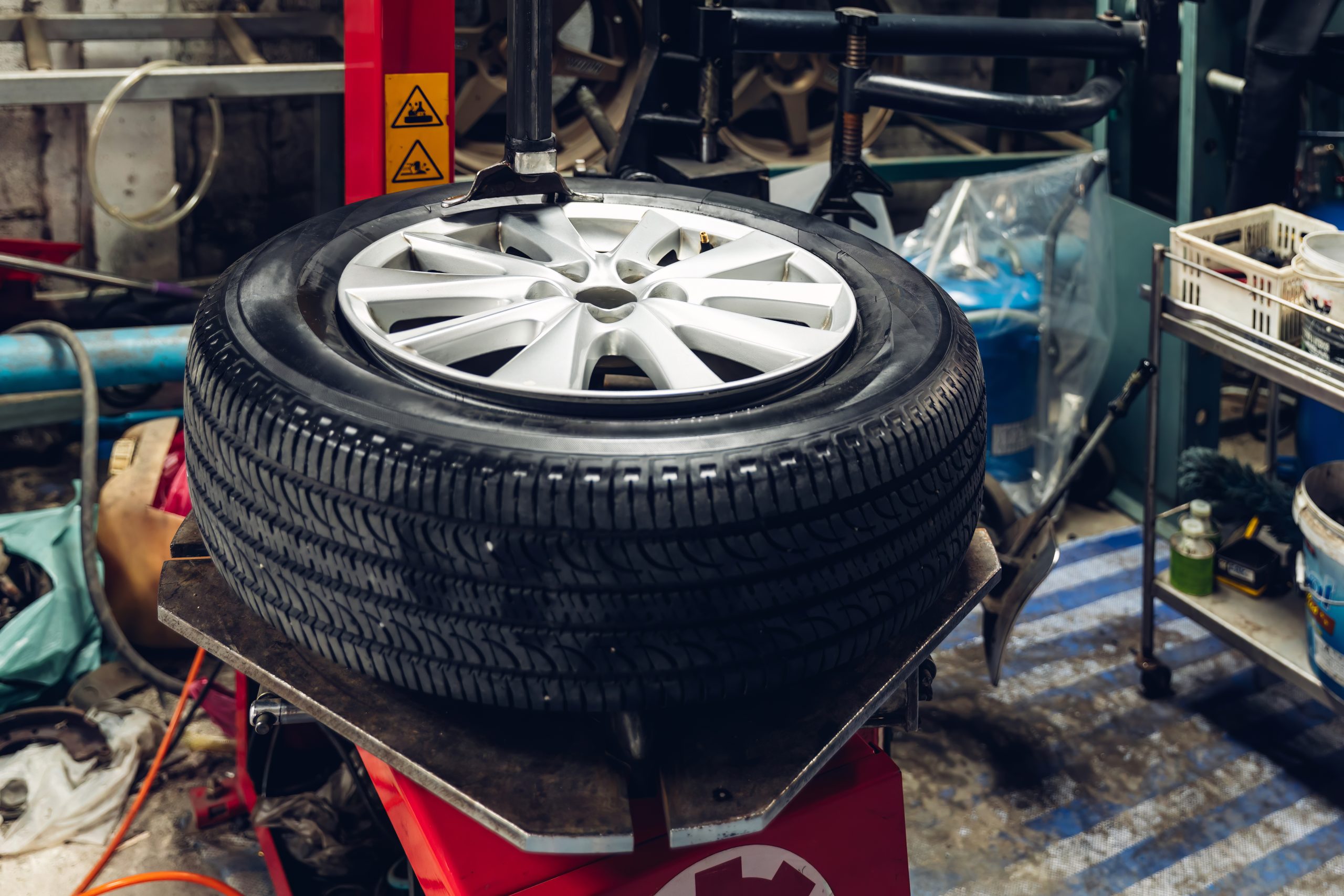 Mechanic removing a tire from the rim after using a tire bead br