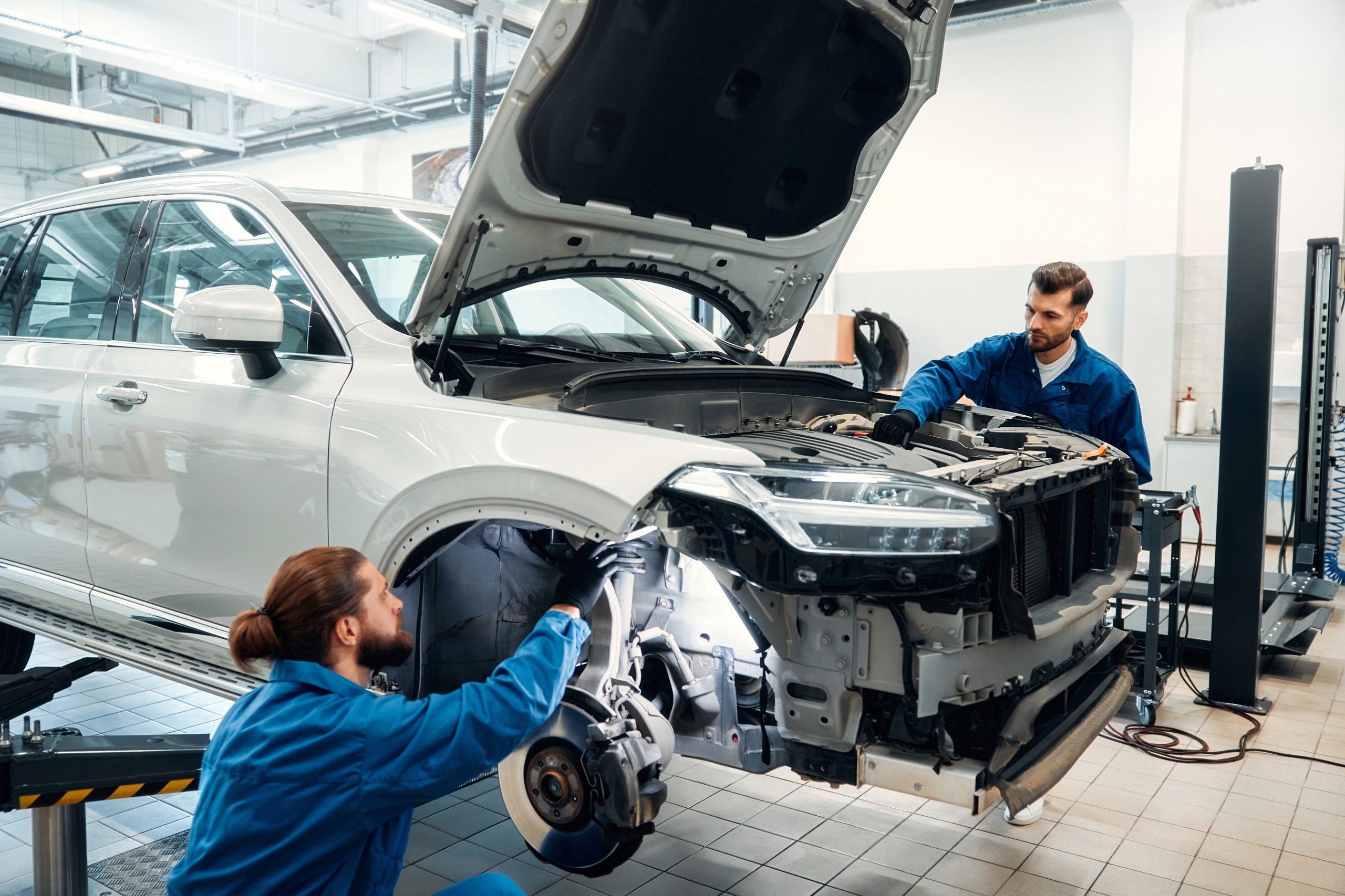 Auto mechanic working in garage. Repair service.